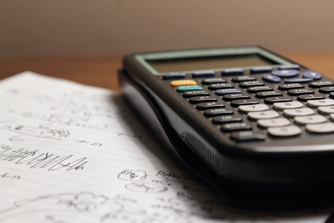 Financial charts and reports spread on a table with a calculator
