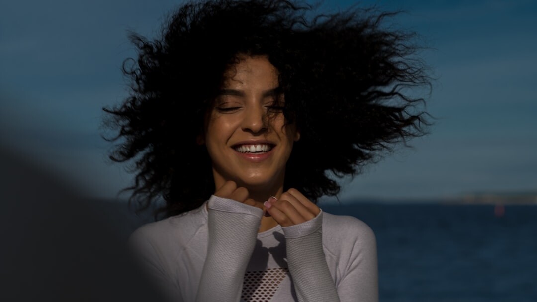 Studio portrait of a smiling businesswoman with curly hair