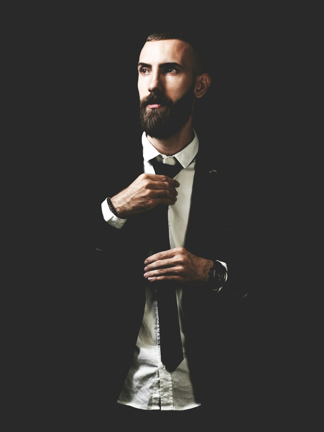 Studio portrait of a bearded man in a business suit